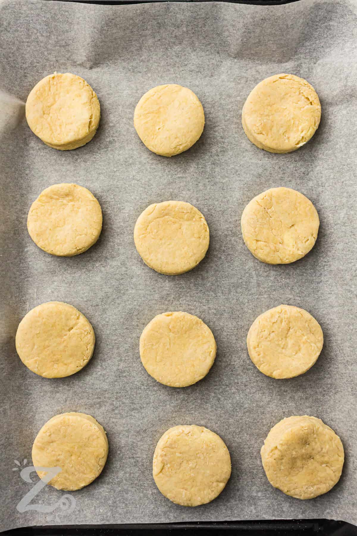 adding shortcakes to sheet pan to bake for Strawberry Shortcake