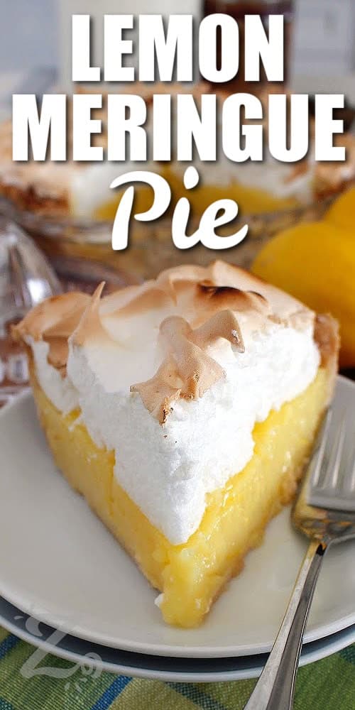 a slice of lemon meringue pie on a white plate with a fork, with lemons and a lemon juicer behind it, with a title