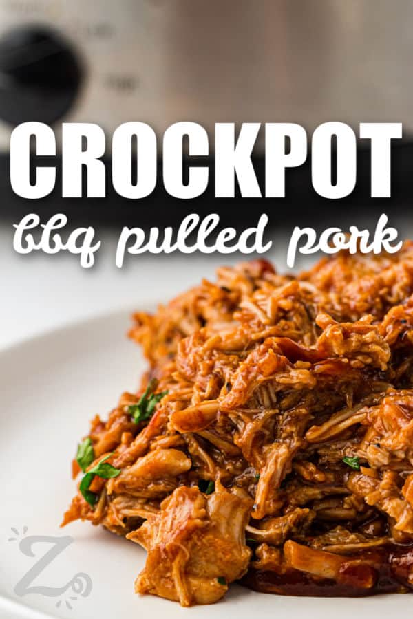 Slow Cooker BBQ Pulled Pork on a plate with the slow cooker in the background and a title