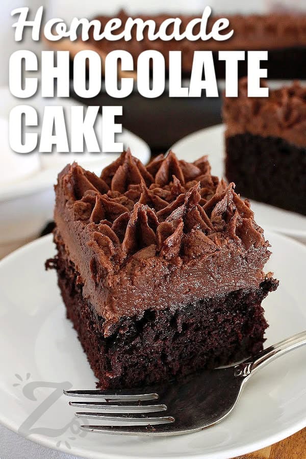 The homemade chocolate cake batter comes together quickly with basic ingredients. It is rich without being too heavy, soft without falling apart, and balanced with deep cocoa flavor in every bite. No matter if you frost it with silky buttercream or enjoy it plain with a simple dusting of powdered sugar, this cake proves that homemade desserts do not need to be complicated to be delicious. Try it the next time you need a simple dessert. #ourzestylife a slice of homemade chocolate cake on a white plate and cake in the background with a title