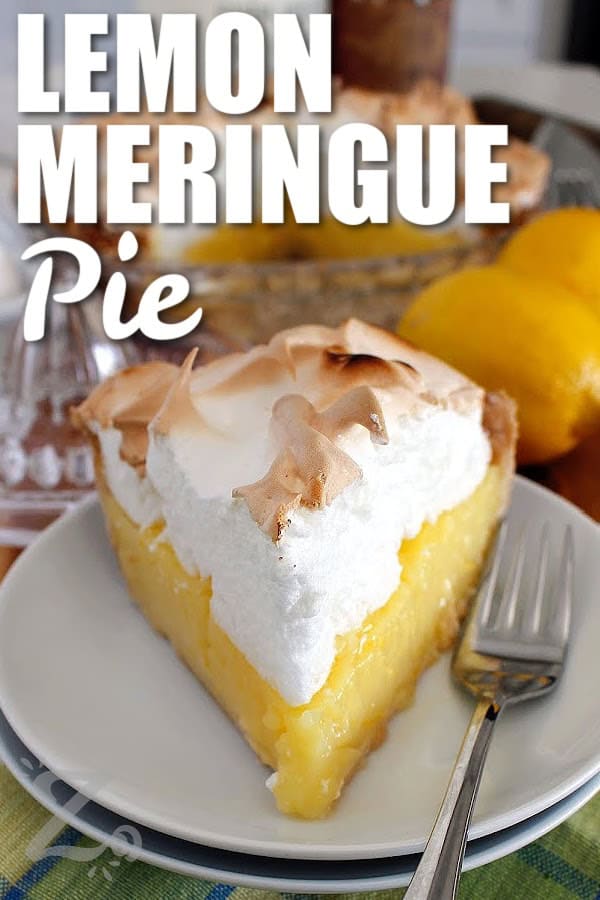 one slice of lemon meringue pie on a white plate, with lemons and lemon juicer behind it, with a title