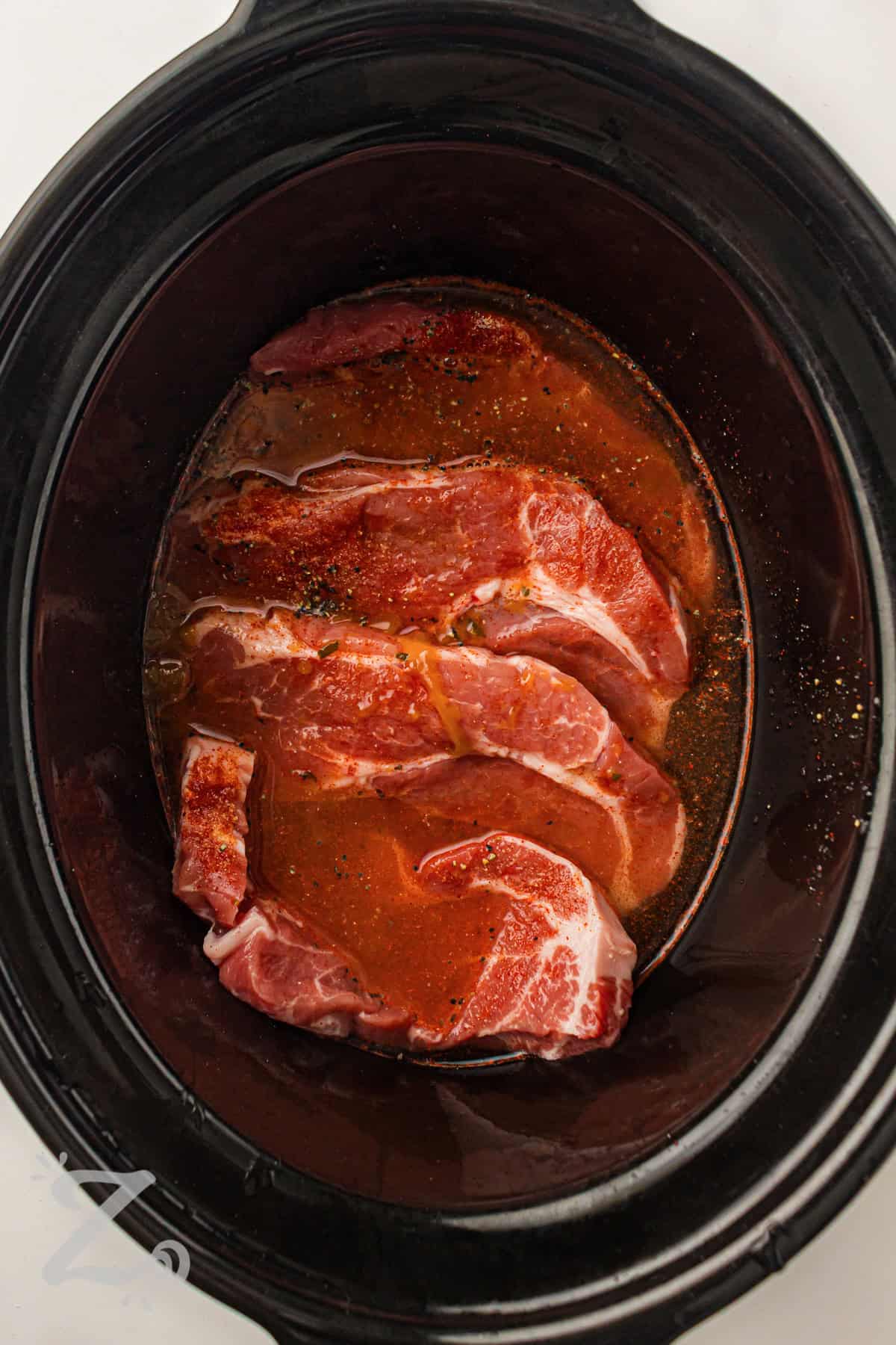 pork in slow cooker with sauce to make Slow Cooker BBQ Pulled Pork
