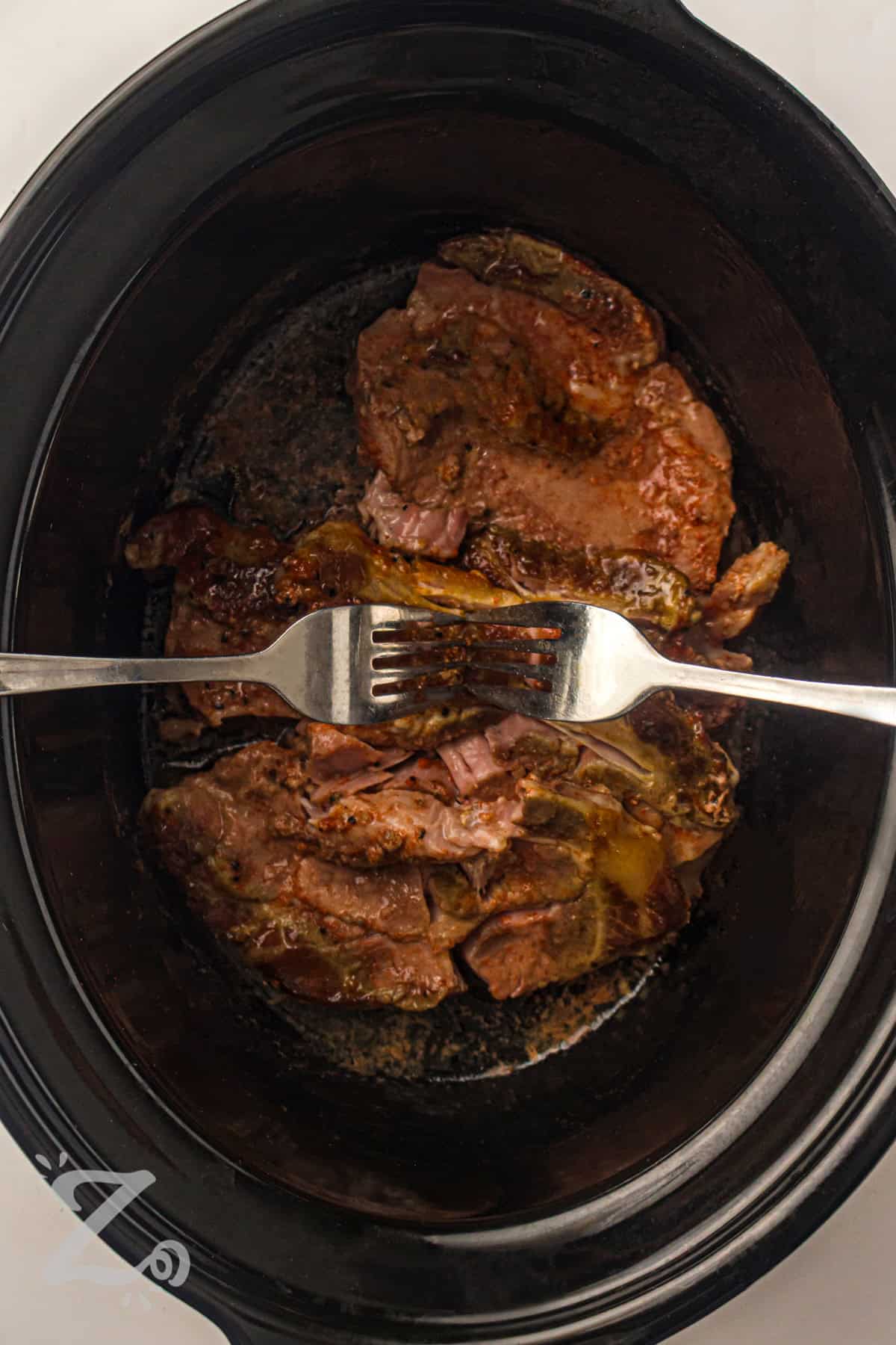shredding pork to make Slow Cooker BBQ Pulled Pork