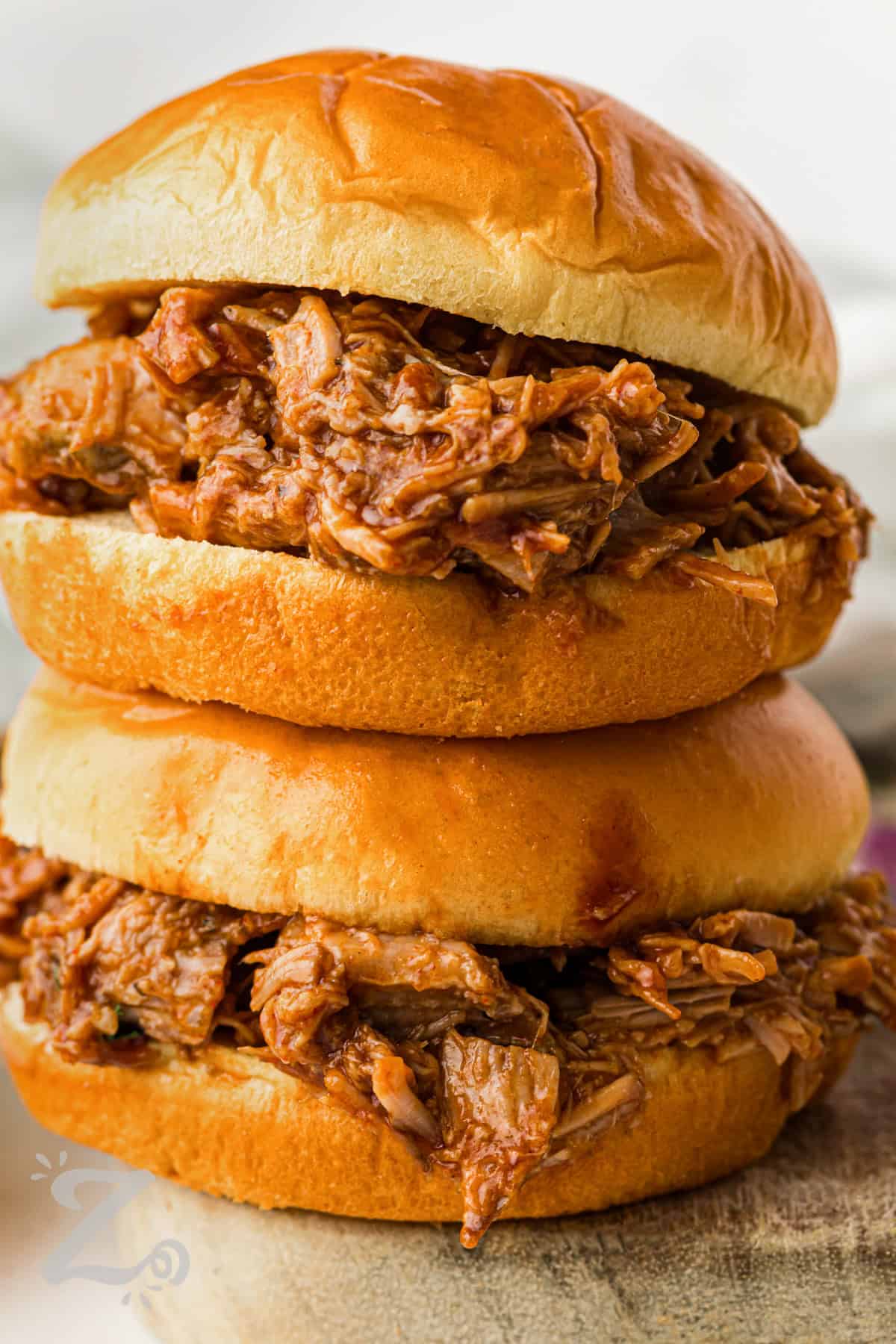 Slow Cooker BBQ Pulled Pork sandwiches in a stack