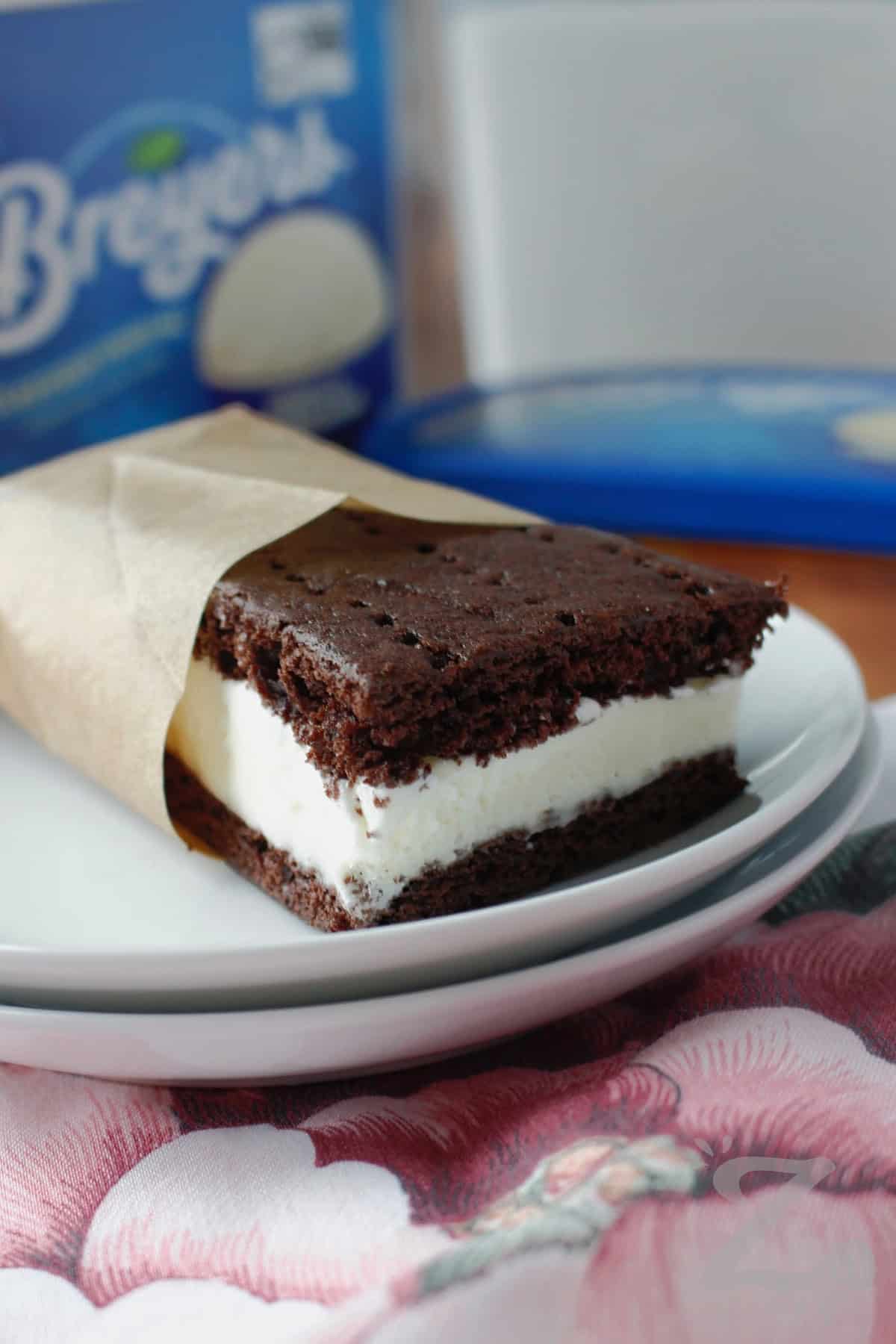 one slice of ice cream sandwich recipe wrapped with parchment on a white plate