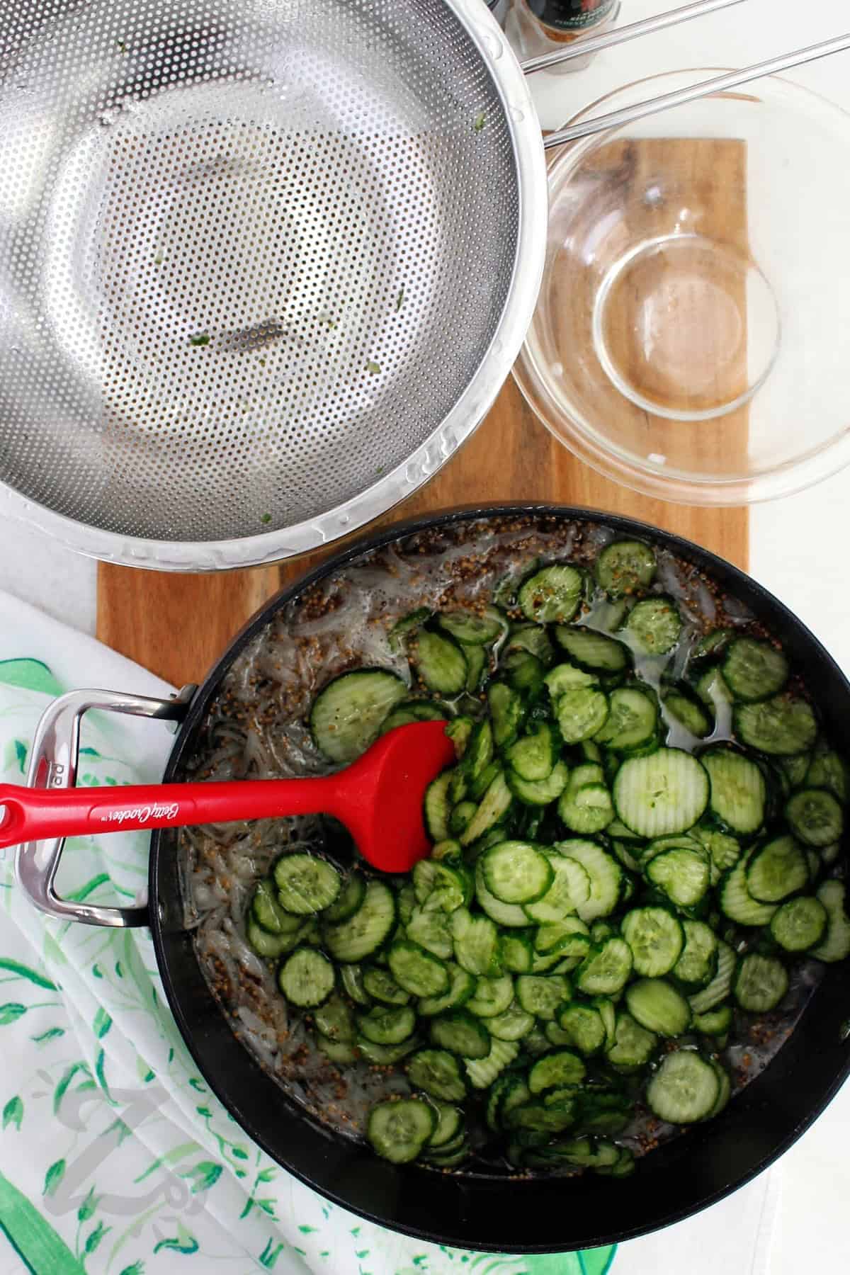 Turn summer cucumbers and onions into sweet, tangy pickles with this Bread and Butter Pickles recipe! It is easy to do perfect for preserving this summer's bounty. With just a few ingredients and straightforward instructions you can make either refrigerator pickles to be enjoyed within 3 months, or try the canning method for long term pantry storage. #ourzestylife process to make bread and butter pickles recipe where onion and sliced cucumbers have been added to brine