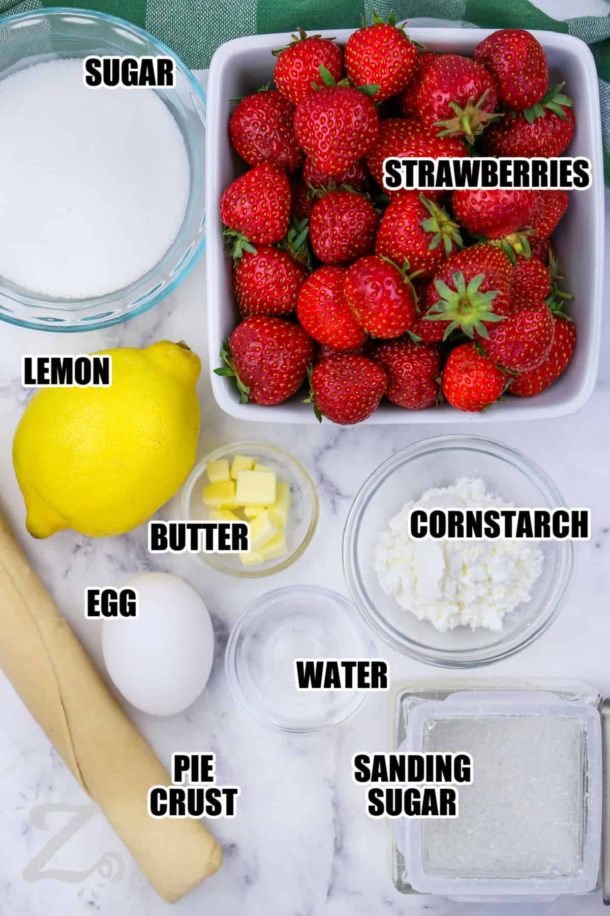 sugar , strawberries , lemon , butter , egg , cornstarch , sanding sugar , water, pie crust with labels to make Strawberry Galette