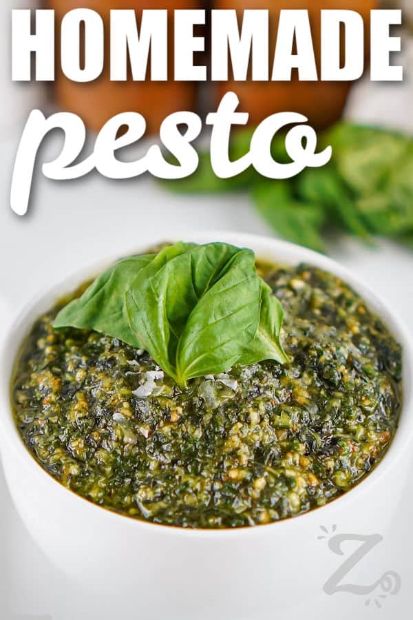 close up of basil Homemade Pesto in a bowl with writing