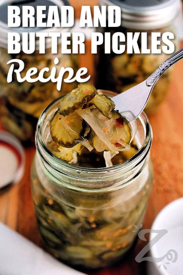 This homemade Bread and Butter Pickles recipe is sweet, tangy, and deliciously crunchy! Whether you're preserving garden cucumbers or stocking your pantry, these classic pickles are simple to make and taste even better after a day or two in the brine. Why not give this recipe a try this summer? #ourzestylife bread and butter pickles recipe in a mason jar with some on a fork with writing