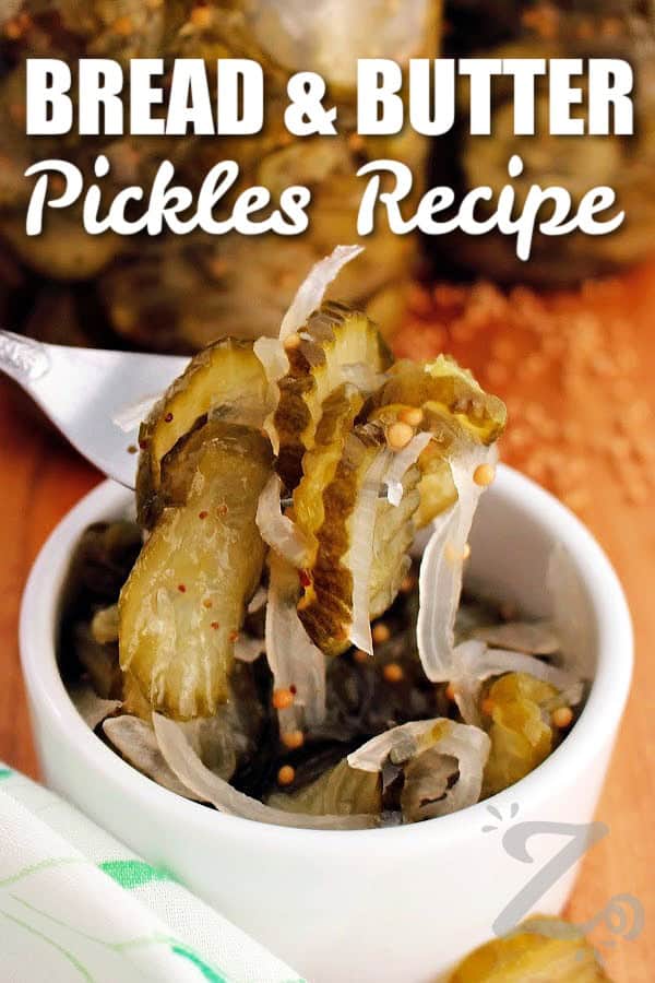 Make this easy Bread and Butter Pickles recipe at home for a sweet and tangy treat this summer. Crisp cucumbers, onions, and a homemade brine create the perfect pickle for burgers, sandwiches, charcuterie boards, or snacking. You can make this recipe for canning or refrigerator style pickles! #ourzestylife bread and butter pickles recipe on a fork with a title