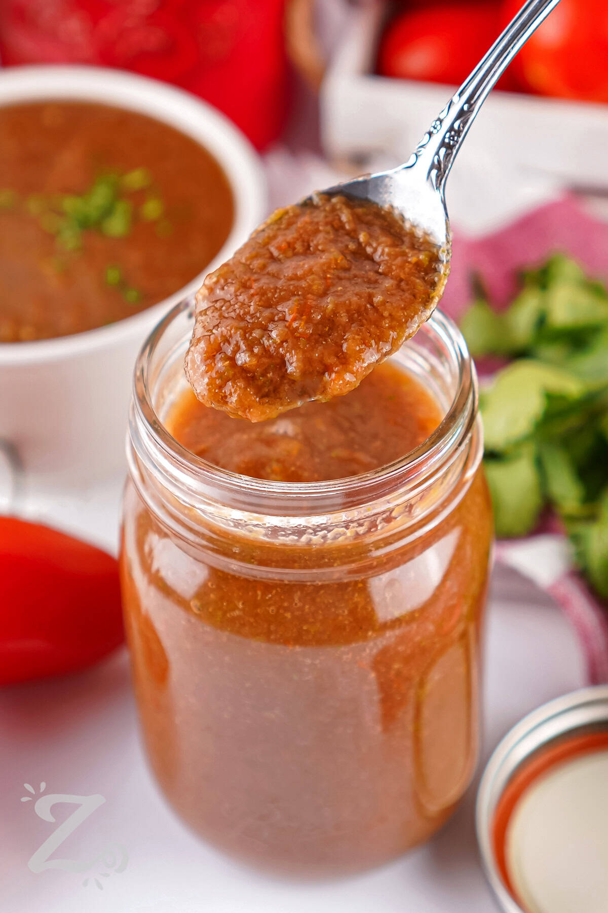 taking a spoonful of Blender Salsa out of the jar
