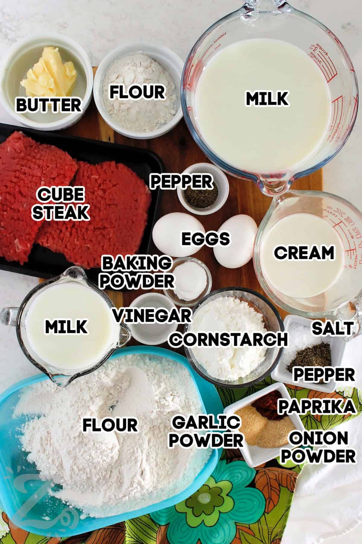 Baking powder, milk, vinegar, flour, cornstarch, garlic powder, onion powder, paprika, pepper, salt used to coat the cube steak. Cream milk, pepper, flour, and butter assembled to make the country gravy.