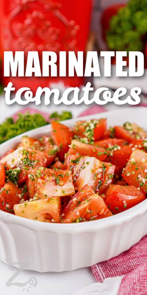 Marinated tomatoes bring together juicy tomatoes, fresh herbs, garlic, lemon, and olive oil in one simple side dish. The fresh ingredients complement each other beautifully, creating a bright flavor that works with grilled chicken, fish, pasta, and bread. This easy tomato recipe is a great way to enjoy fresh produce while adding something special to dinner. Save the recipe and try it this season. #ourzestylife dish of Marinated Tomatoes with writing