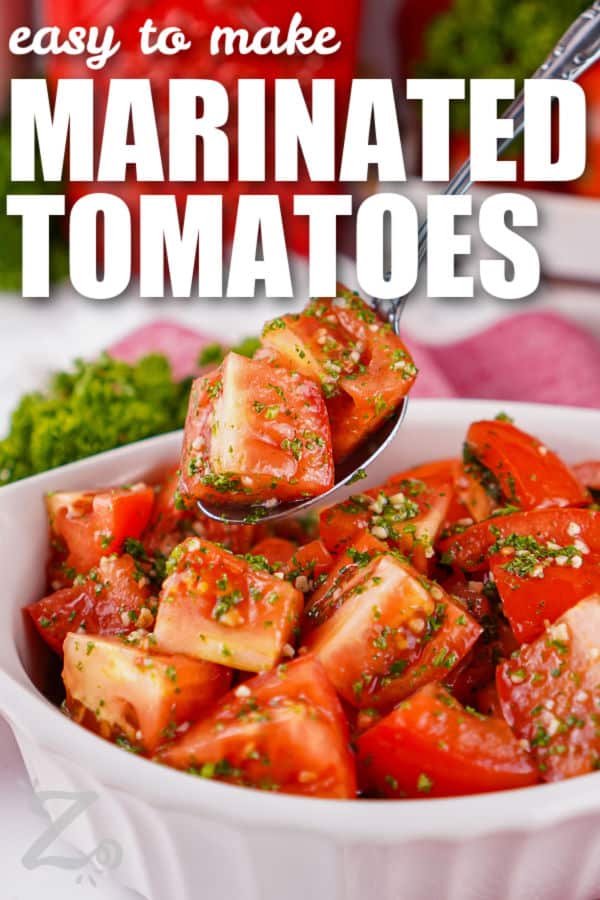 Marinated tomatoes turn juicy Roma tomatoes into a bright, flavorful side dish with very little fuss. Fresh parsley, garlic, lemon juice, and olive oil create a simple marinade that brings out the best in ripe tomatoes. Serve them alongside grilled chicken, fish, pasta, or crusty bread for a fresh summer addition. Make this easy tomato recipe when you want something simple and delicious. #ourzestylife easy to make Marinated Tomatoes with writing
