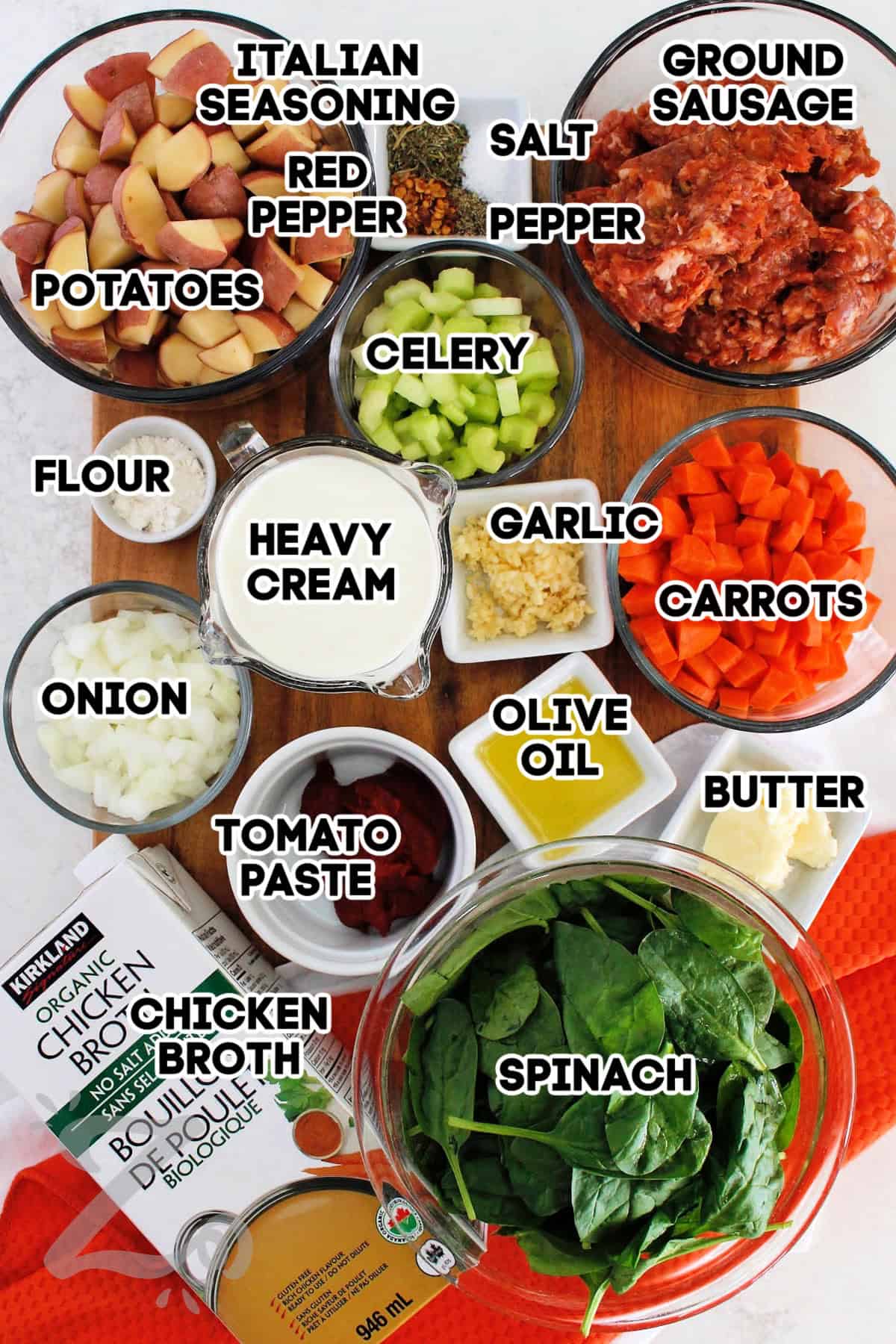 This easy Sausage Potato Soup is packed with tender vegetables, Italian sausage, potatoes, and spinach in a creamy broth. Italian seasoning adds savory herb flavor while red pepper flakes provide just a little kick. The result is a comforting soup that warms up a chilly day. Why not try a bowl tonight? #ourzestylife ground sausage, garlic, carrots, olive oil, butter, spinach, chicken broth, tomato paste, onion, flour, heavy cream, celery, potatoes, pepper, red pepper flakes, Italian seasoning, and salt to make sausage potato soup.