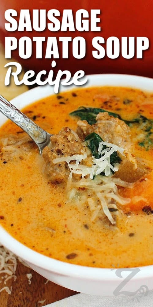 This Sausage Potato Soup brings together Italian sausage, tender potatoes, fresh spinach, and vegetables in a rich and creamy, savory broth. Tomato paste and Italian seasoning add extra flavor, while red pepper flakes bring a little warmth. It is a hearty soup the whole family can enjoy so why not try it this week? #ourzestylife sausage potato soup in a white bowl with shredded parmesan garnish and a title.