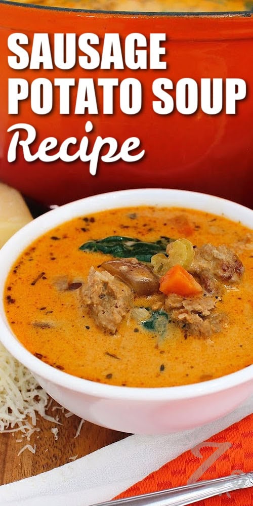 Looking for a filling soup that can be made in one pot? This Sausage Potato Soup combines savory Italian sausage, tender red potatoes, vegetables like sweet carrots, bright spinach, and a creamy broth. A little red pepper adds a gentle kick to every spoonful. Add this sausage and potato soup to your dinner menu tonight! #ourzestylife sausage potato soup in a white bowl with freshly shredded parmesan on the side, with a title
