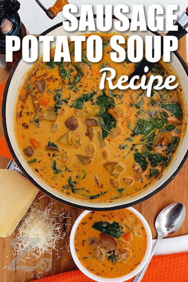Sausage Potato Soup is a cozy one pot dinner with Italian sausage, tender potatoes, carrots, celery, spinach, in a creamy broth. A touch of red pepper adds just enough heat to balance the rich, savory flavors. Sausage and potato soup is hearty enough for a chilly weeknight meal so why not make a pot tonight? #ourzestylife sausage potato soup in a pot with a bowl of soup and freshly shredded parmesan and a spoon on the side, with a title.