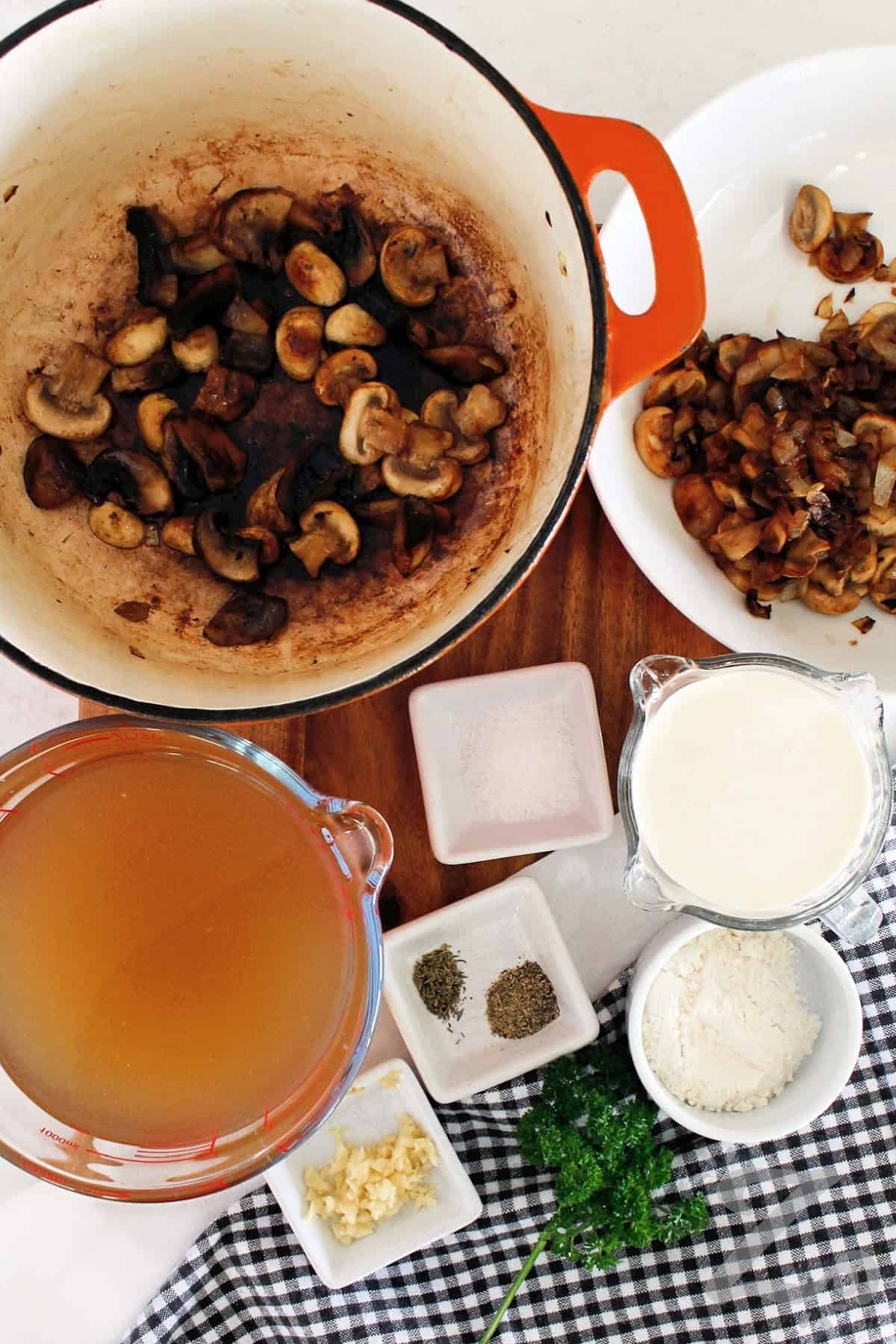 process to make homemade cream of mushroom soup where the mushrooms are cooked in batches in pot.