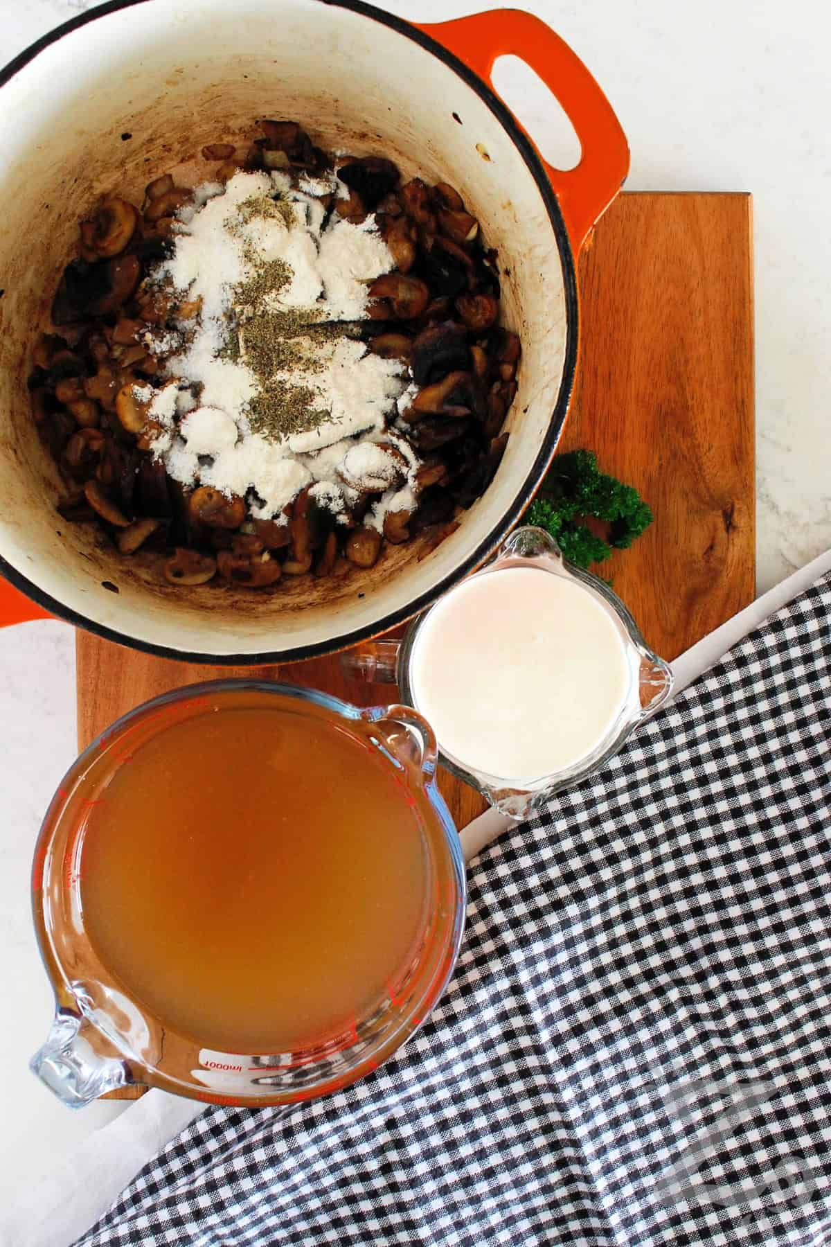 Flour and seasoning added to sauteed mushrooms to make homemade cream of mushroom soup.
