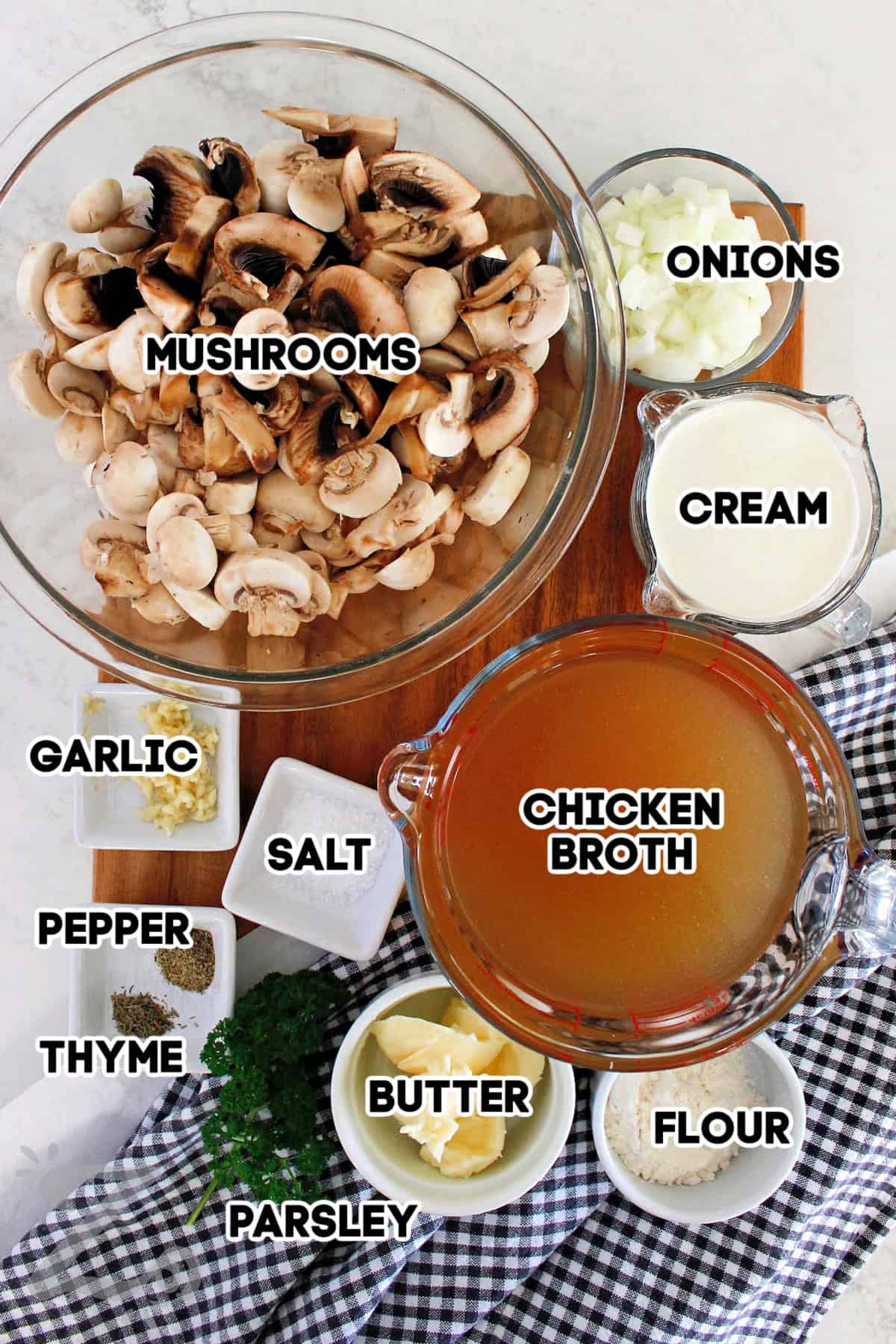 Mushrooms, onions, cream, chicken broth, flour, butter, fresh parsley, thyme, pepper, kosher salt, and minced garlic assembled to make homemade cream of mushroom soup.